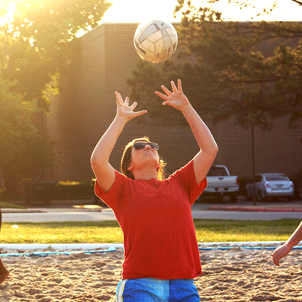 person going to hit volleyball that is coming towards them